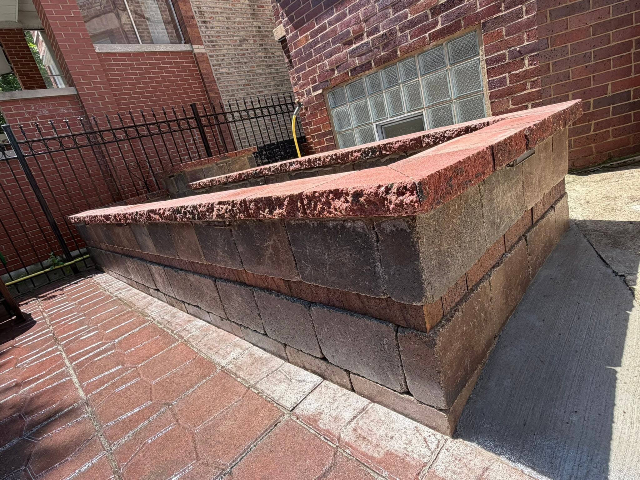 Brick and stone retaining wall with a stone cap