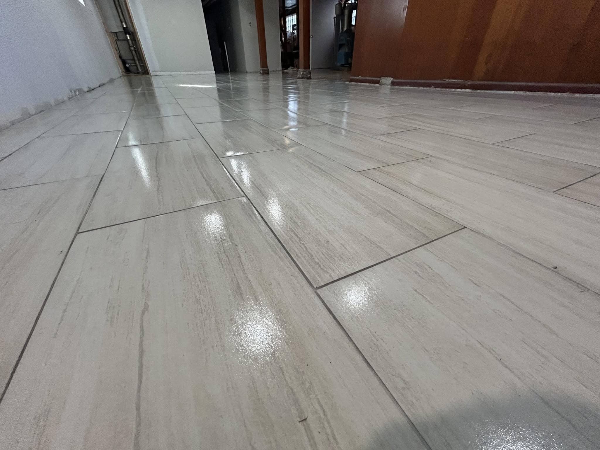 Glossy plank-style tile flooring installed