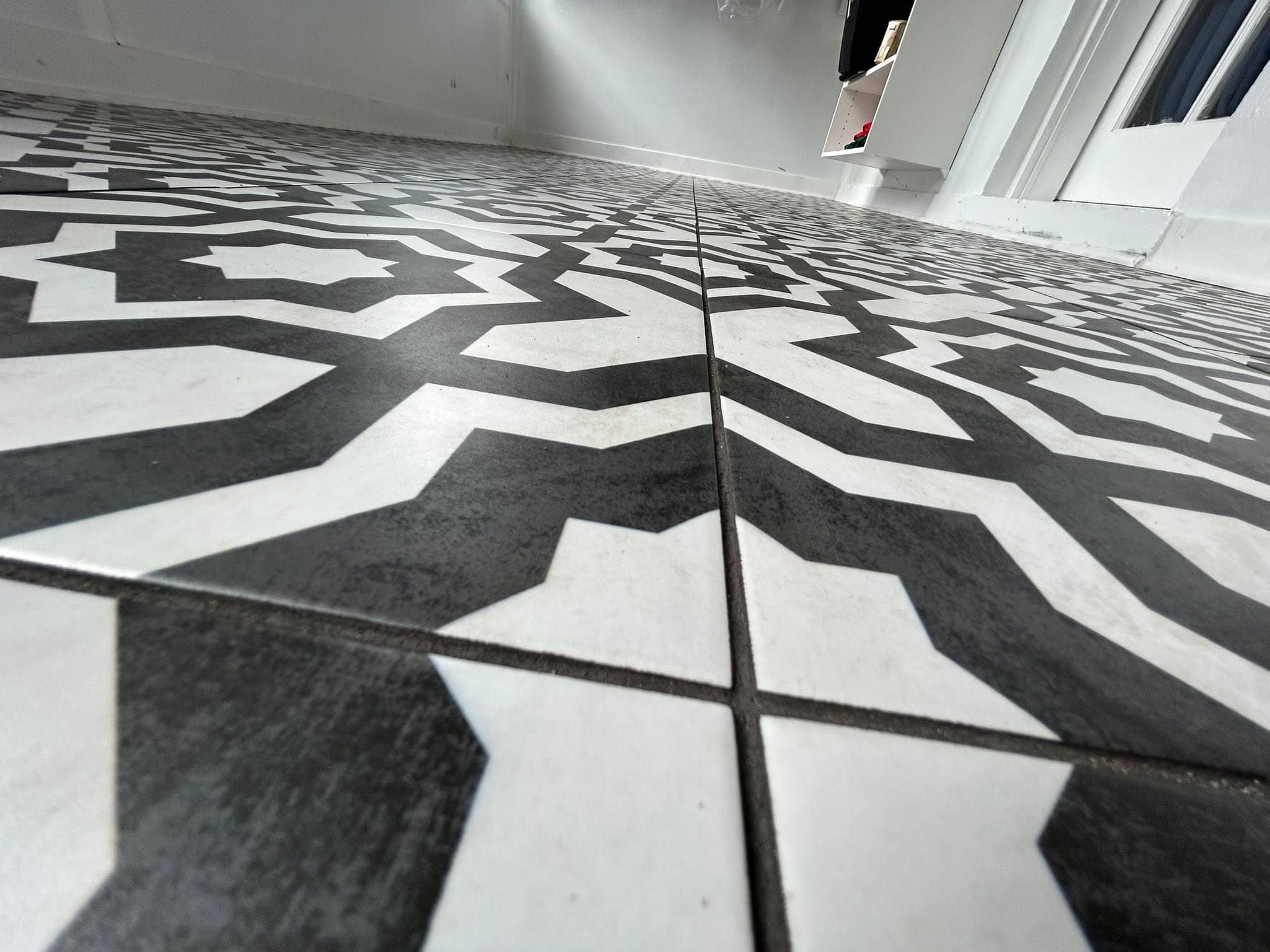 Close-up of a black and white star-patterned tile floor