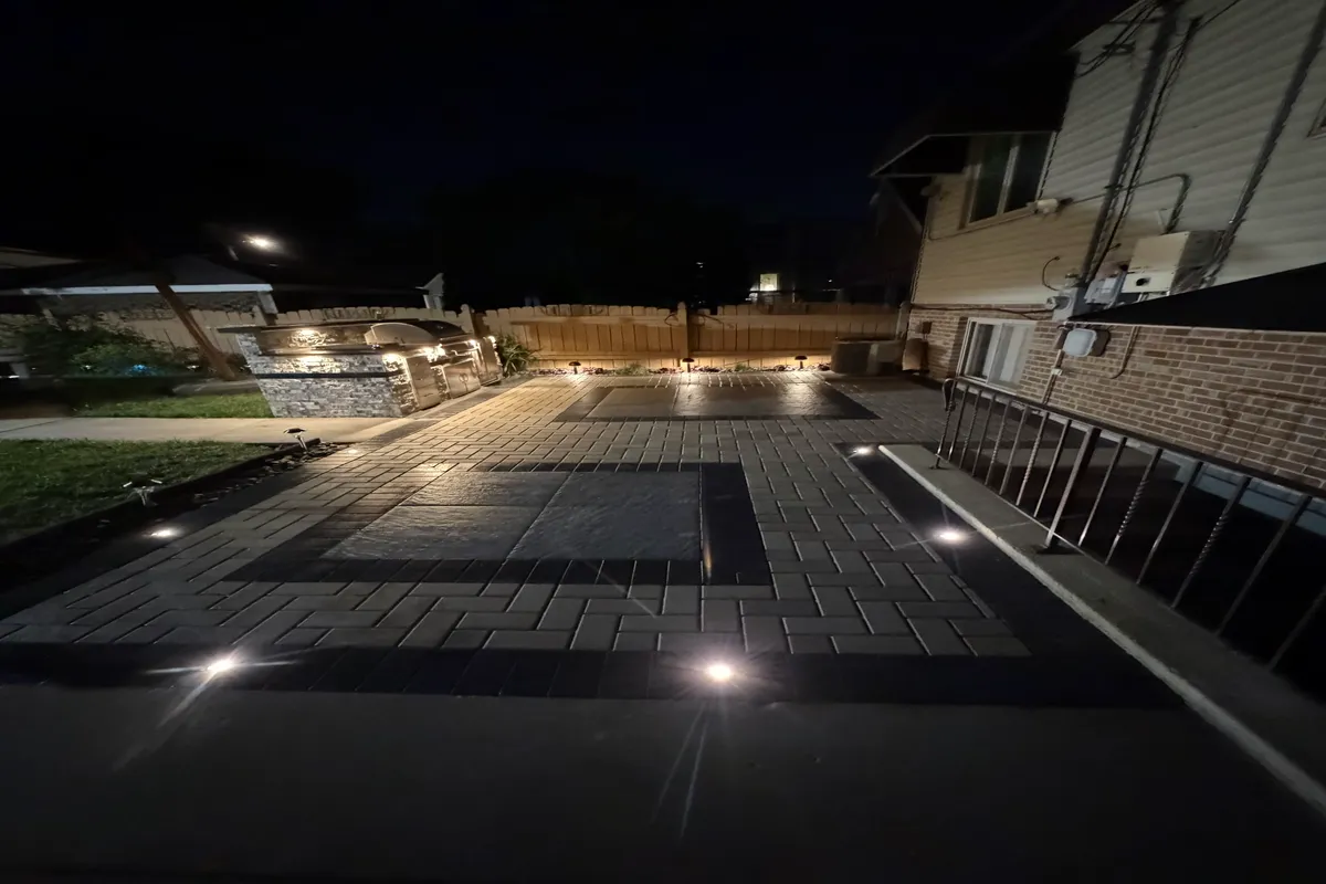 paver patio installation designed with landscape lighting